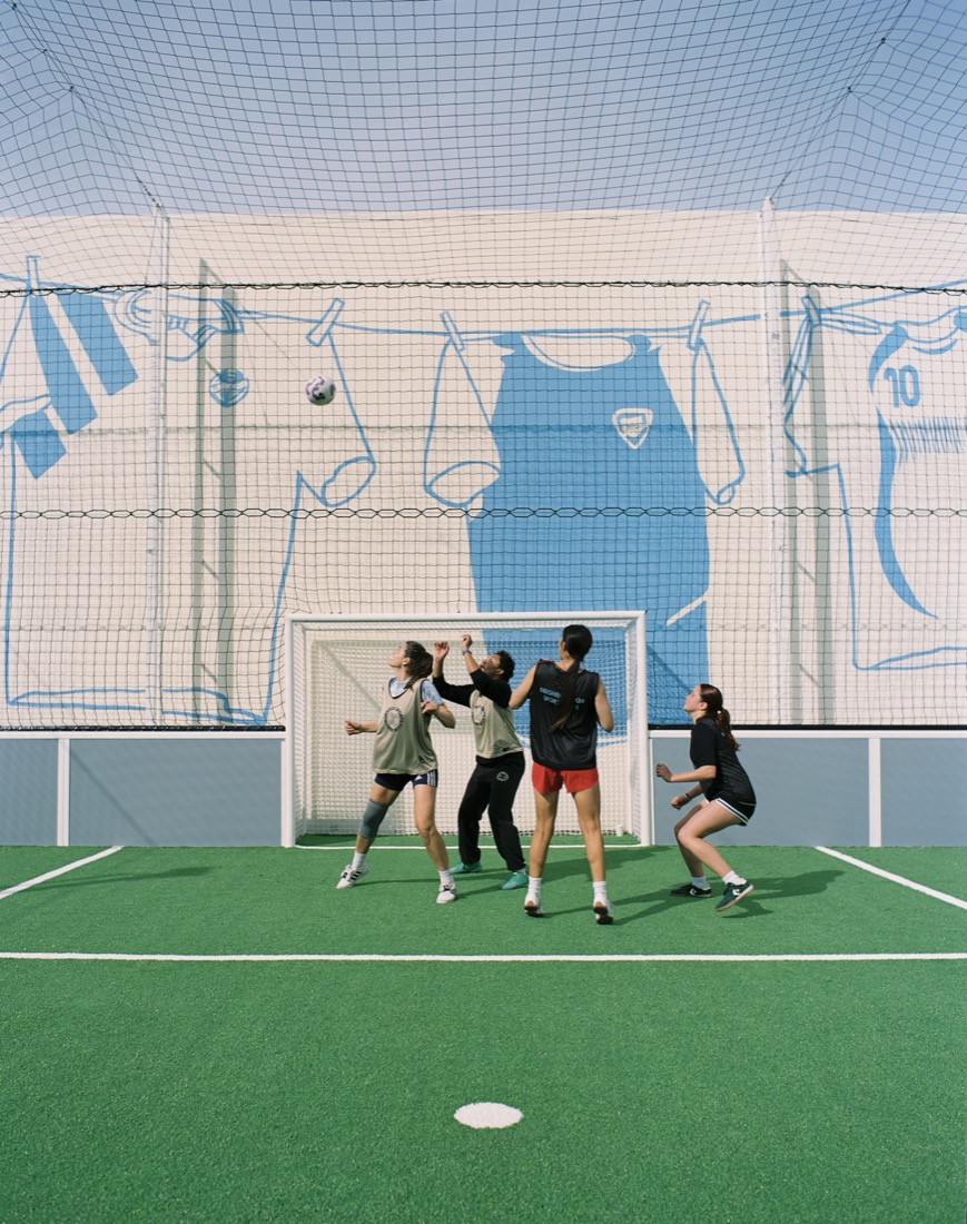 Players jumping for a header in front of the goal at NSC